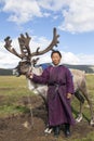 A Dukha woman stands with reindeer in northern Mongolia