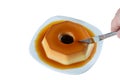 Man cutting a condensed milk pudding with caramel syrup, traditional Brazilian sweet (white background Royalty Free Stock Photo