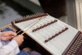 A dulcimer which Thai traditional music instrument. Man playing hammered dulcimer with mallets. Royalty Free Stock Photo