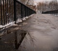 A dull asphalt bridge with forged fences. Street photo with a bridge.