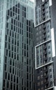 Dull blue glass in front of tall buildings reflecting against the Bangkok