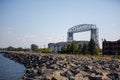 Duluth Aerial Lift bridge on the coast of Lake Superior with rocks on the shore against blue sky Royalty Free Stock Photo