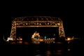 Duluth Minnesota aerial lift bridge with ore ship entering harbor at night Royalty Free Stock Photo