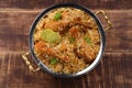 Dum chicken biriyani on a rustic background