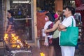 Filipinos gather to pray and light religious candles,at a holy shrine next to the iconic Dumaguete Belfry,that helped save the