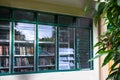 Dumaguete, the Philippines - 15 Jan 2021: public library glass window with book covers. Library window view