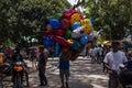 Dumaguete, the Philippines - 10 September 2018: people celebrating local festival Fiesta. Colorful air balloon seller.