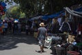 Dumaguete, the Philippines - 10 September 2018: street market and people walking. Rustic stall with cheap clothes