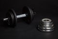 Dumbbell and barbell discs for workout on black background Royalty Free Stock Photo