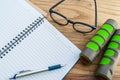 Dumbbell, glasses with diary book on wood background Royalty Free Stock Photo