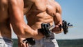 Dumbbell. Muscular bodybuilder guys, exercises with dumbbells. Strong bodybuilder, perfect deltoid muscles, shoulders Royalty Free Stock Photo