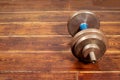 Dumbbell over wooden background on the right