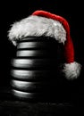 Dumbbell plates with Santa Claus hat for Christmas gym. Royalty Free Stock Photo