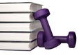 A dumbbell and stack of books for the concept of learning to be fit and healthy.