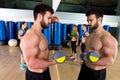 Dumbbell weightlifting man women group at mirror