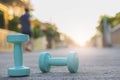 Dumbbell weights and bottle on street blurred background.Metaphor Fitness and workout concept exercise Health lifestyle muscle Royalty Free Stock Photo