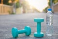 Dumbbell weights and bottle on street blurred background.Metaphor Fitness and workout concept exercise Health lifestyle muscle Royalty Free Stock Photo