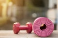 Dumbbell and yoga mat on table Royalty Free Stock Photo