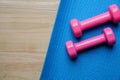 Dumbbell and yoga mat on table Royalty Free Stock Photo