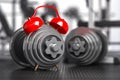 Dumbbells and alarm clock in gym.  Time for workout gym concept Royalty Free Stock Photo