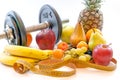 Dumbbells and assorted fruits and meter healthy lifestyle weight loss concept Royalty Free Stock Photo