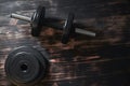 Dumbbells on a dark wooden background. Concept CrossFit