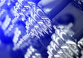 Dumbbells in gym closeup photo. Shiny metallic barbell weights in blue neon.