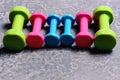 Dumbbells made of pink, green and cyan plastic Royalty Free Stock Photo