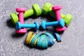 Dumbbells made of pink, green and cyan plastic