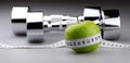 Dumbbells with measuring tape and apple for diet Royalty Free Stock Photo