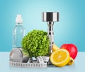 Dumbbells with measuring tape, vegetables and Royalty Free Stock Photo