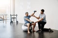 Dumbbells, physiotherapy and balance with doctor and old man for rehabilitation, training and stretching. Healthcare Royalty Free Stock Photo
