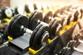 Dumbbells row in a gym. sport sunny background Royalty Free Stock Photo