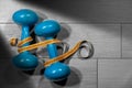 Dumbbells and tape measure on the gym floor Royalty Free Stock Photo