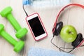Dumbbells, water, apple and smartphone Royalty Free Stock Photo