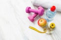 Dumbbells, water, towel, apple, and tape measure Royalty Free Stock Photo