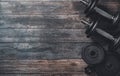 Dumbbells and weights on wooden floor