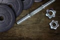Dumbells and weights on the wooden floor. Fastening screws and barbells Royalty Free Stock Photo