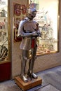 Dummy in knight armor with sword standing outside souvenir shop