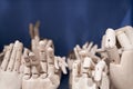 Dummy model wooden human hands gesture set on shelf on blue background close up. Mannequin hand collection closeup.