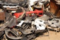 Dump of broken bumpers and parts of cars on the street like garbage