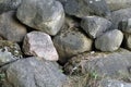 Dump of cameos at the edge of the forest. Boulders. Granite. Fallen leaves and needles Royalty Free Stock Photo