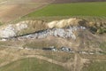 a dump landfill located near the wheat plantation, dumping waste in the prohibited area. arable land, Royalty Free Stock Photo