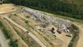 Dump municipal solid waste landfill city, drone aerial video shot, bulldozer compacts garbage trash rubbish litter