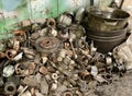 Dump of old auto parts in the garage of an auto mechanic. A bunch of unusable car parts. Garbage from worn auto parts