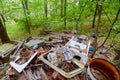 Dump old metal objects in the woods, rusty scrap metal. Environ Royalty Free Stock Photo