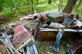 Dump old metal objects in the woods, rusty scrap metal. Environ Royalty Free Stock Photo