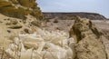 Dump of old plastic bottles sun-burned in the desert in the desert between stones on a background of mountains Royalty Free Stock Photo