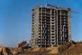 Dump truck dumps its load of sand and soil on construction site for road construction or for foundation work.  Tower crane Royalty Free Stock Photo