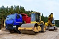 Dump truck, Excavator, Dozer and Vibro Roller Soil Compactor at road construction and bridge projects in forest. Heavy machinery